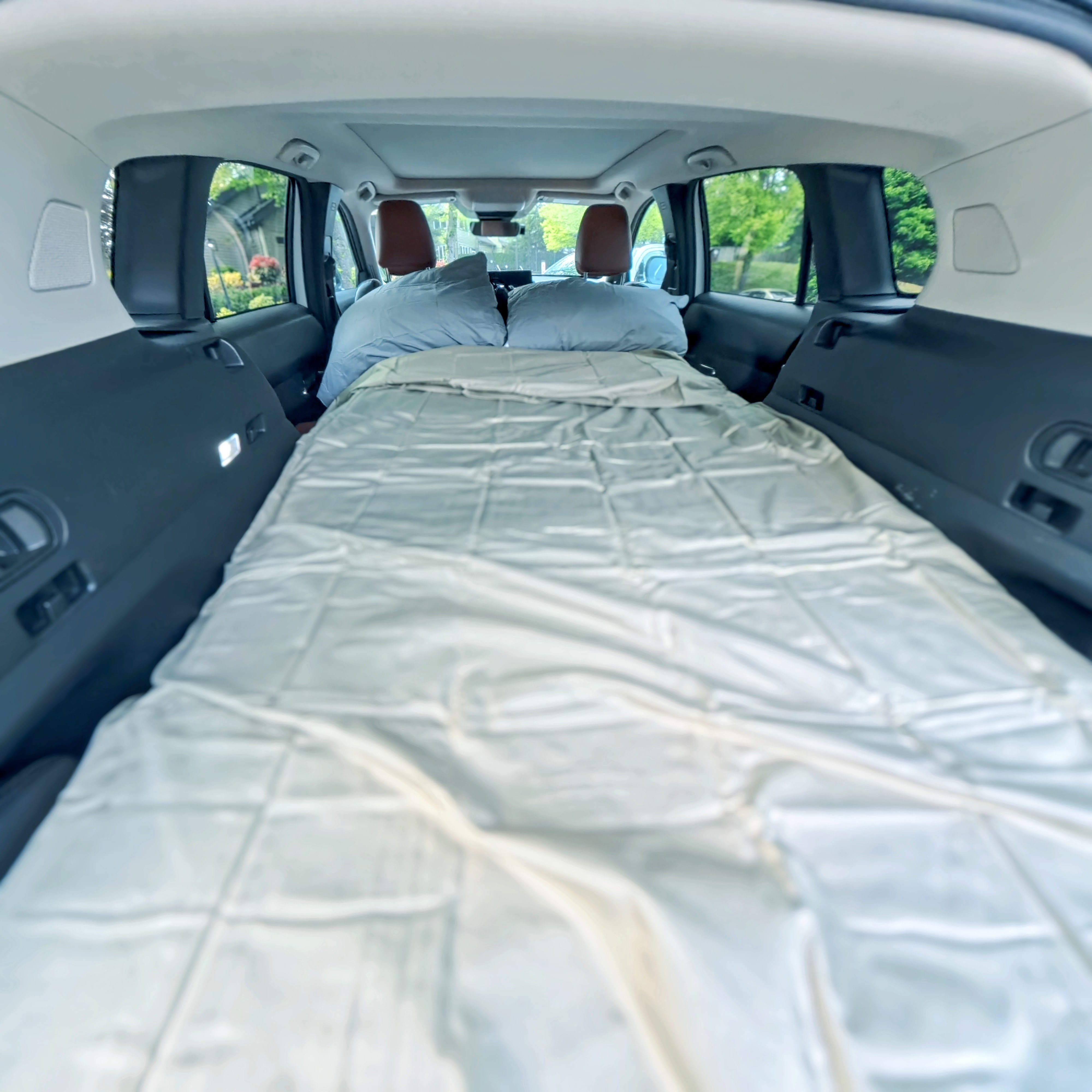 The sleeping platform deployed as a bed inside the car