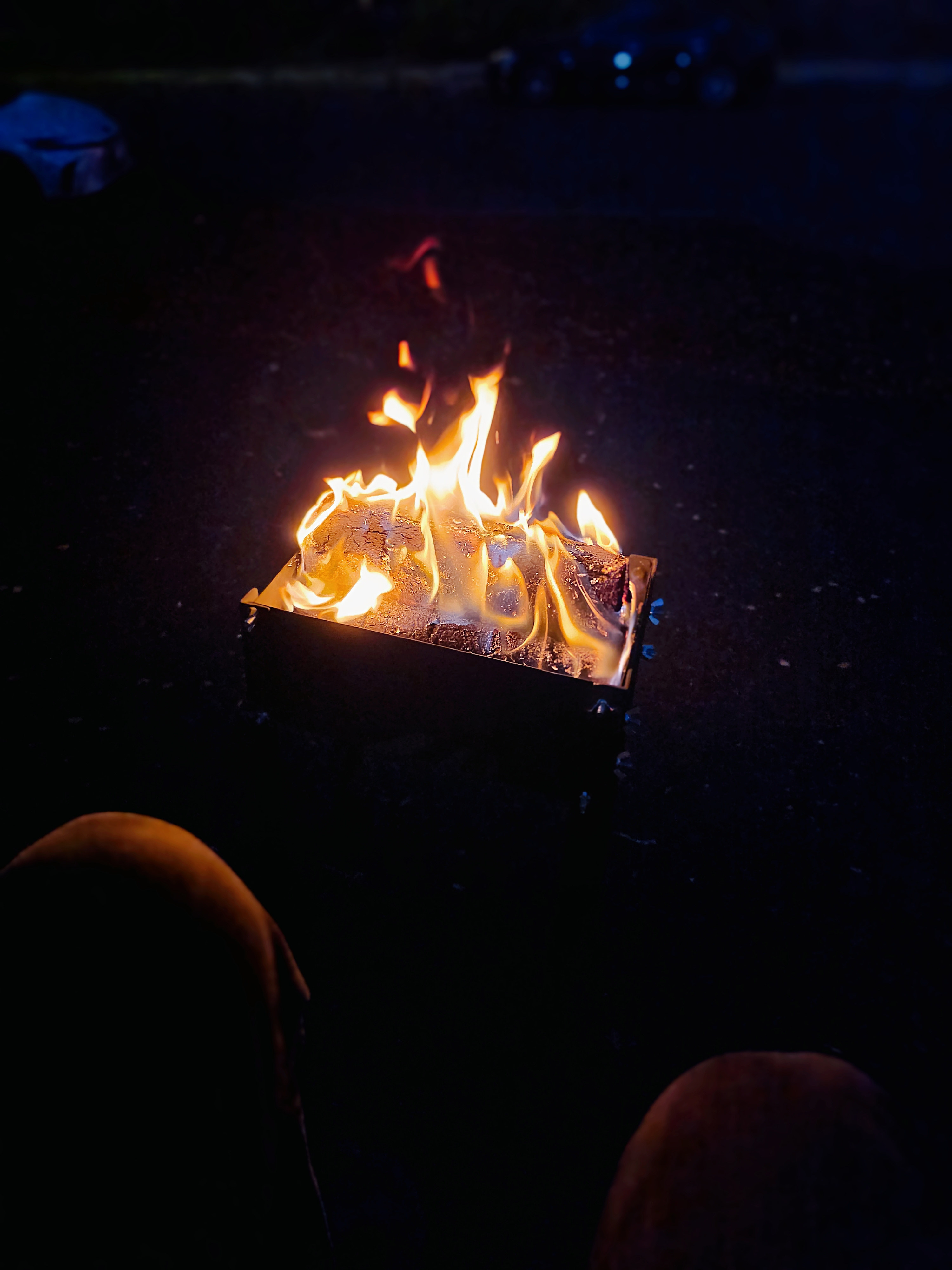 The flat-pack firepit burning at night